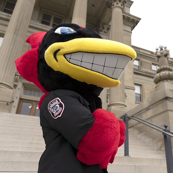 Cy mascot stands in front of Beardshear Hall.