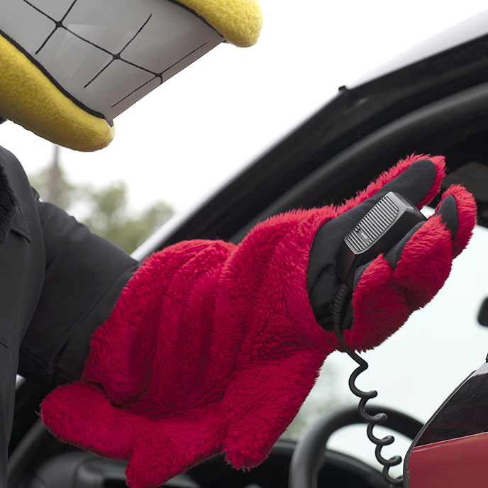 Closeup of Cy mascot using the ISU Police car radio.