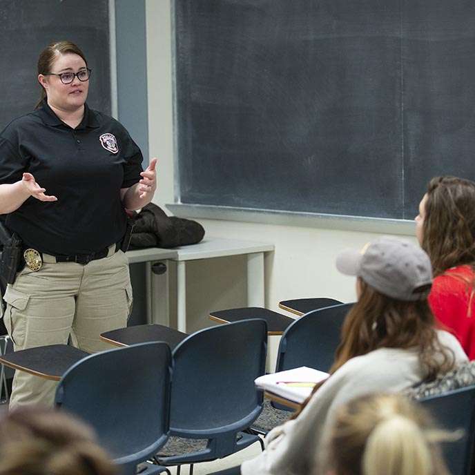 Natasha Greene presents to students in a classroom.